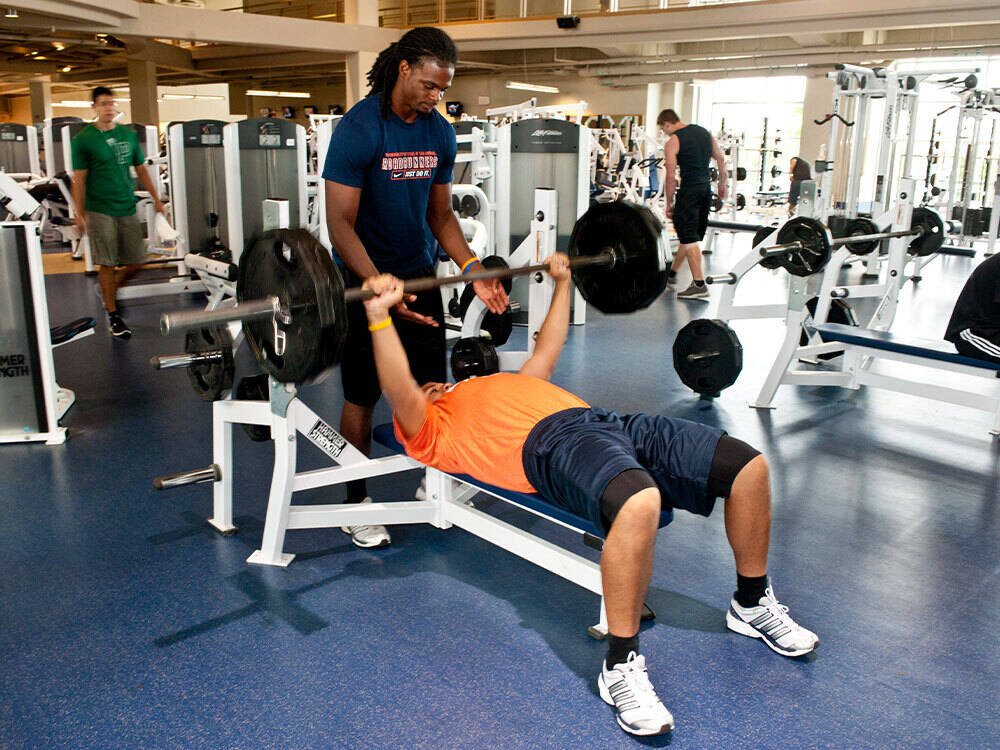 two utsa student lifting in a gym