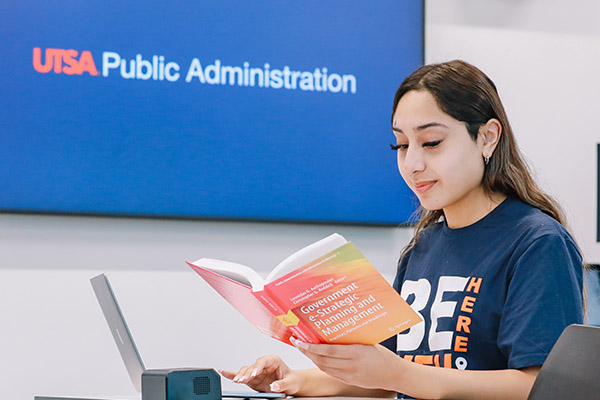 Public Administration student reading a textbook