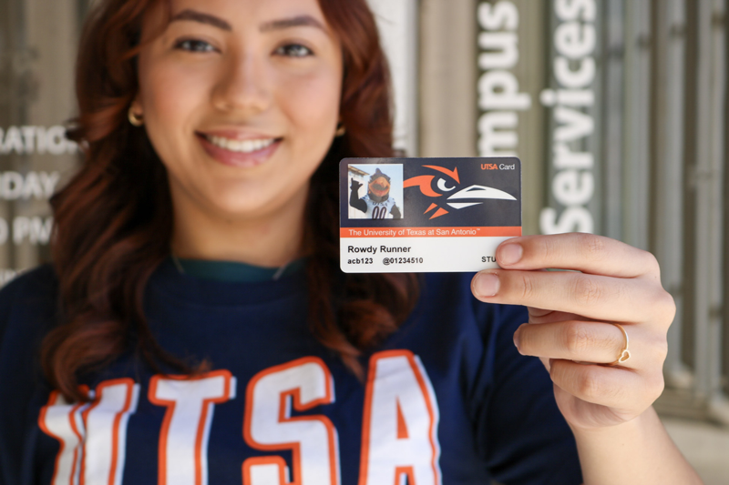 Student holding an id card