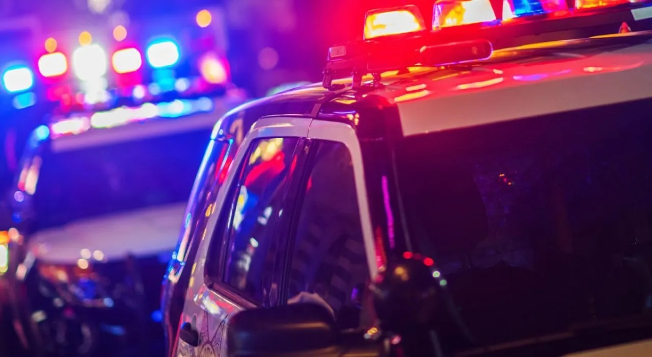 Police cars with emergency lights on at night